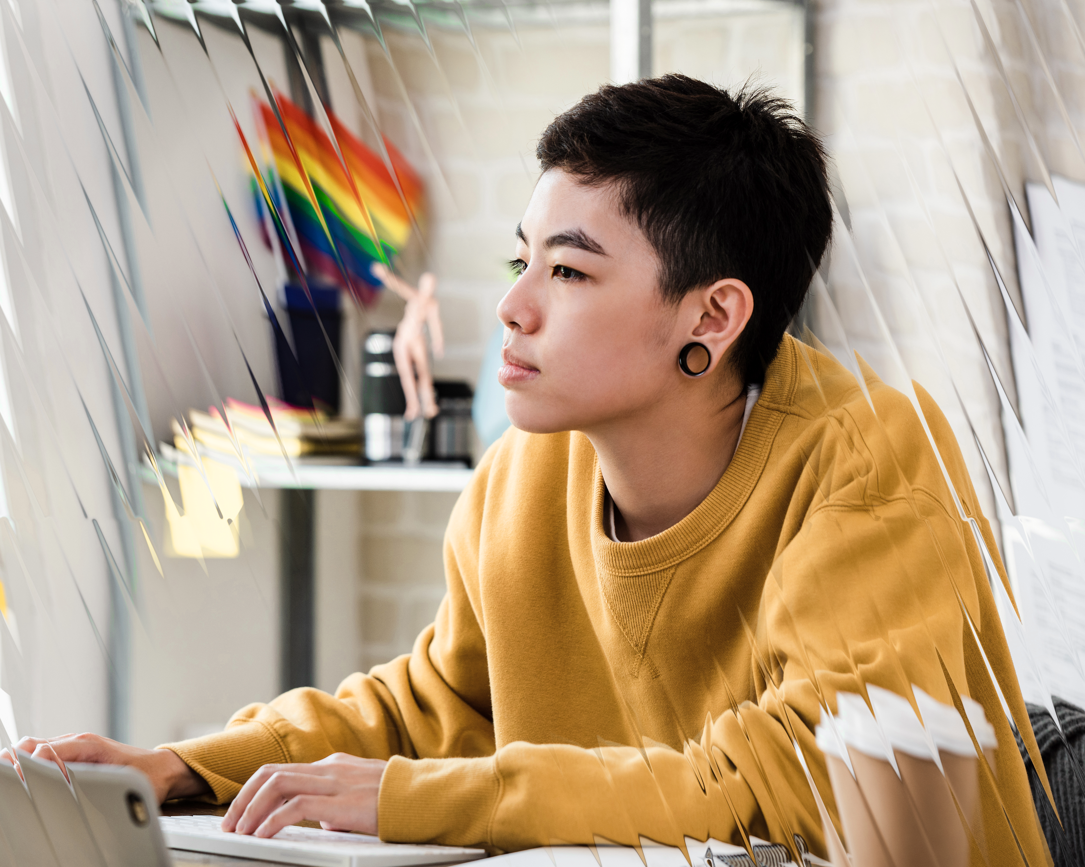 Yellow cool student looking intently at screen